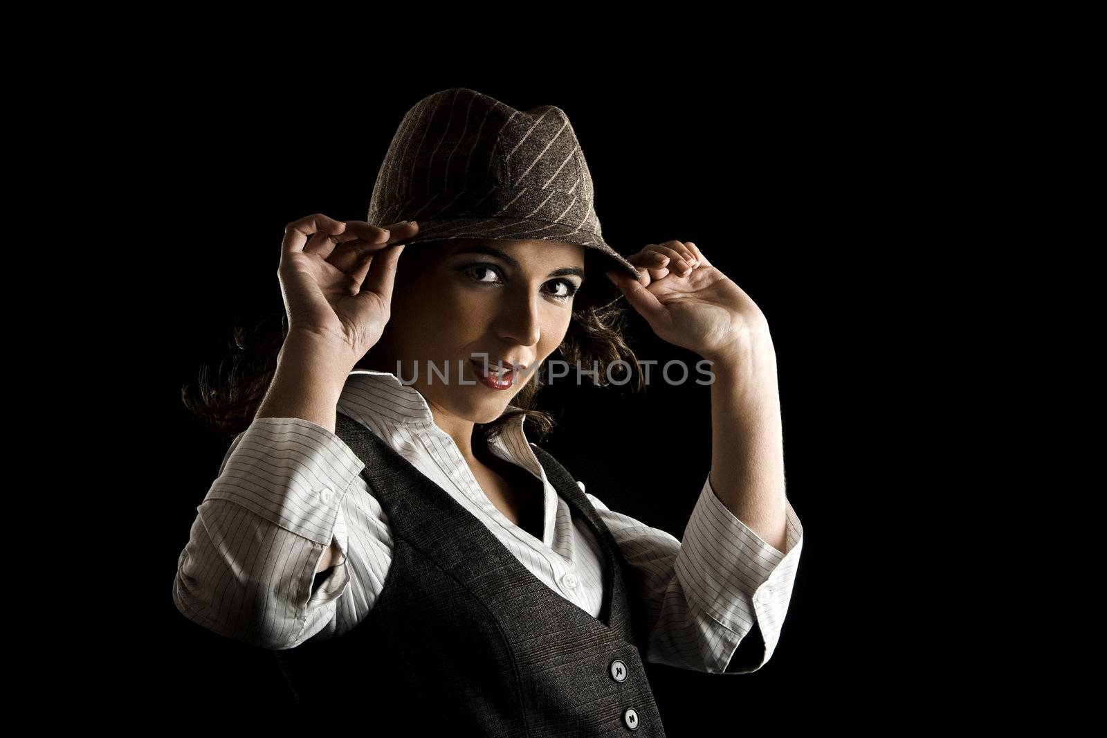 Young woman portrait with hat on a black background

