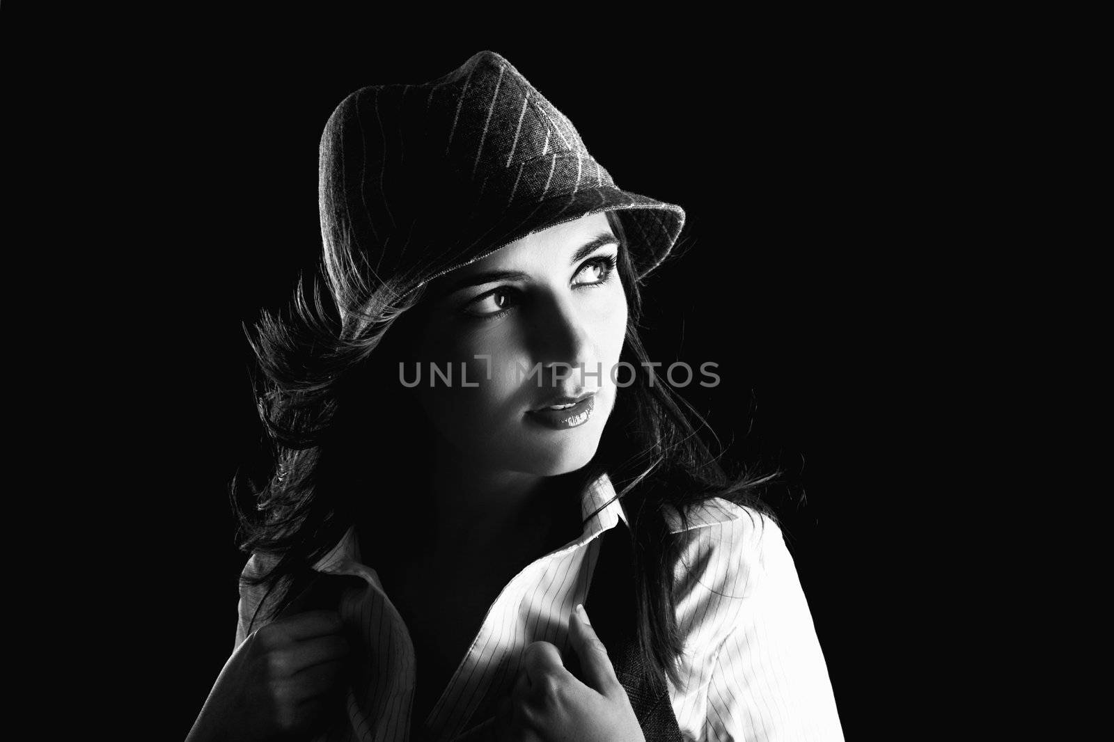 Young woman portrait with hat on a black background

