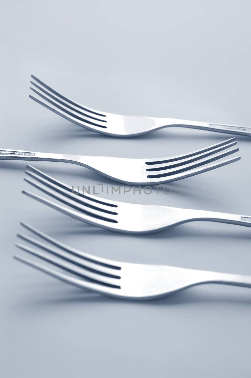 silver forks on light background