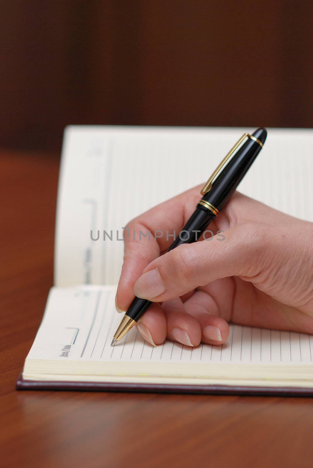 hand writing memo on notebook