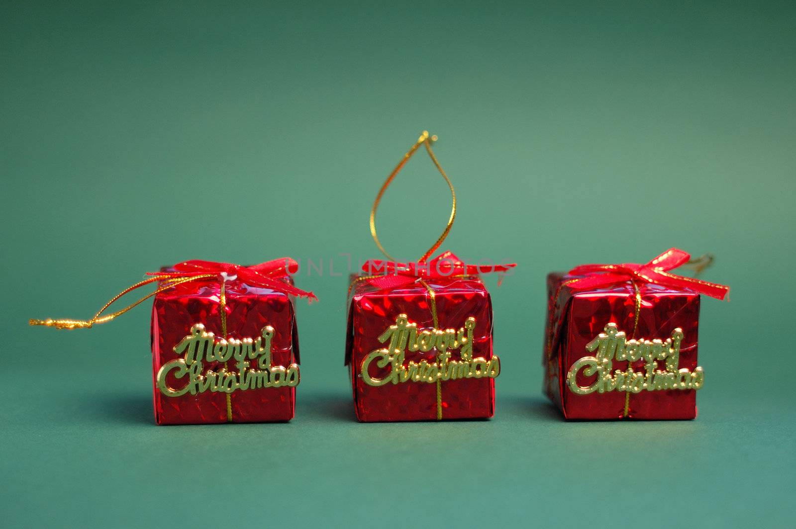 Red gifts on green background. Christmas decoration.
