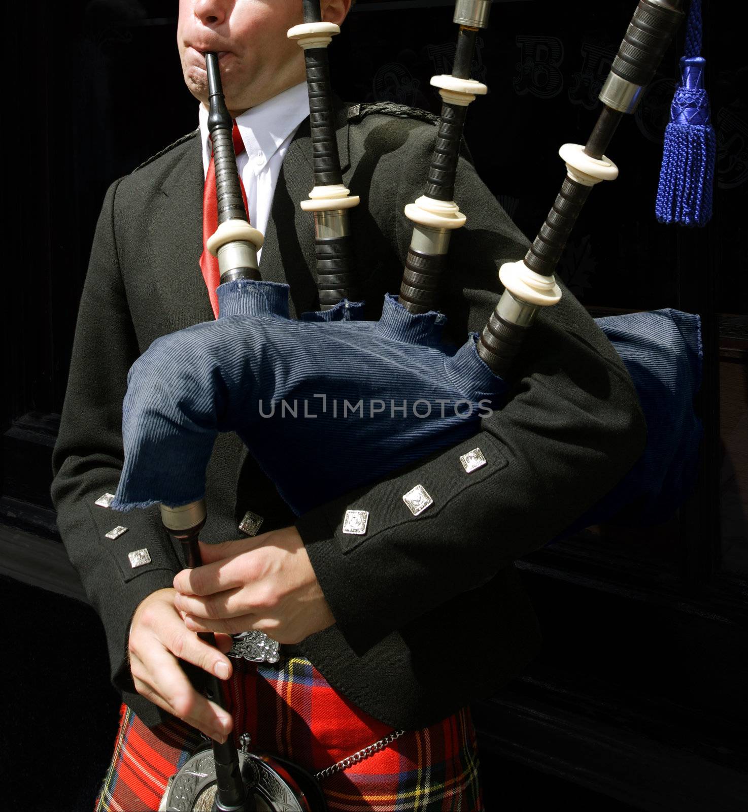 Drumsticks resting on a snare drum between sets of a live show.Bagpiper blowing his pipes in Edinburgh, Scotland.
