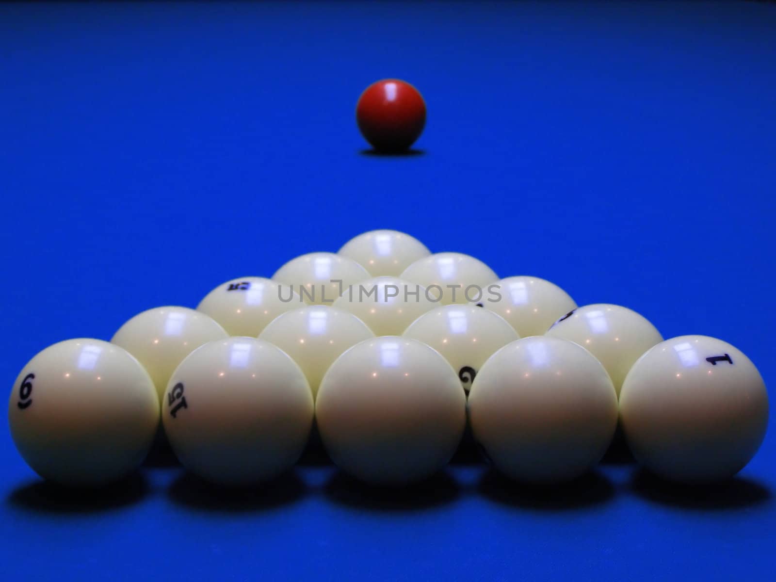 Billiard spheres are built and await the beginnings of the game of chance in the dark-blue field.