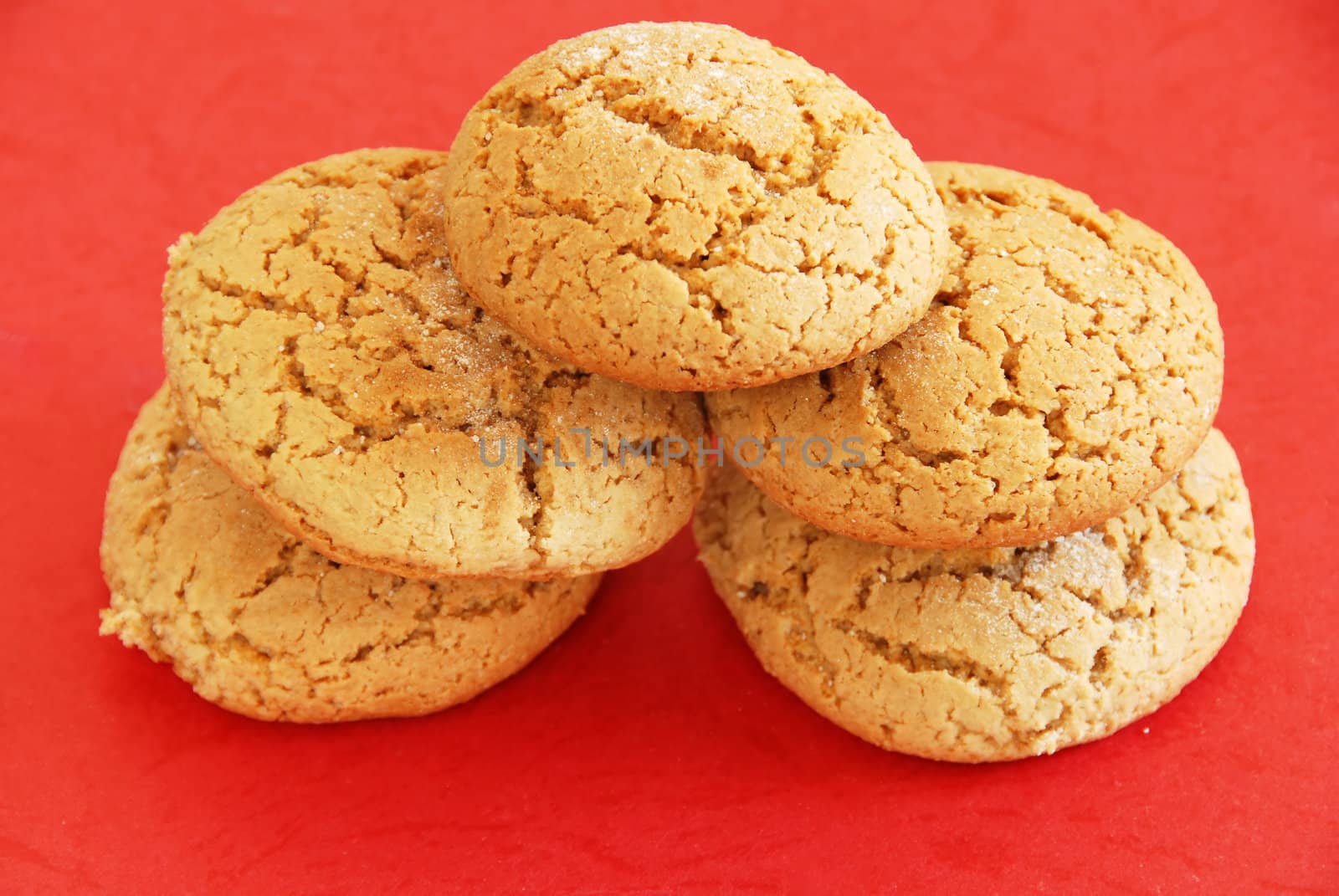 five fresh appetizing oatmeal cookies over red background