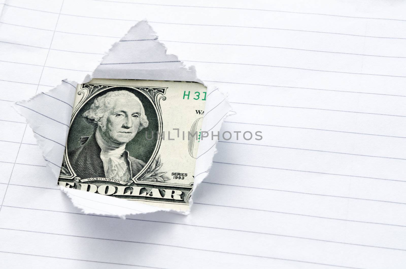 Lined paper torn with window opening showing US dollar.