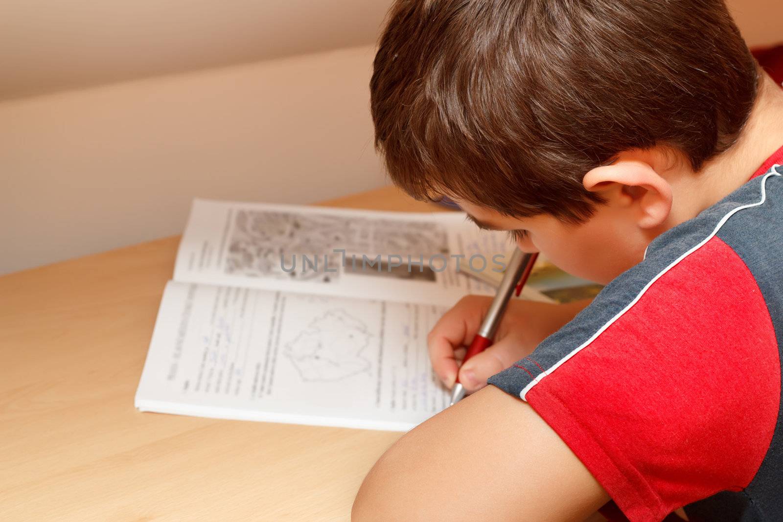 boy doing homework, writing text from workbook by artush