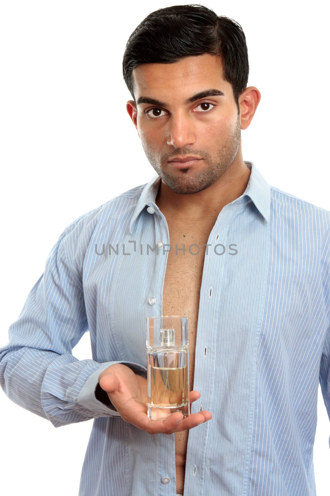 A man holds a bottle of perfume fragrance in one hand