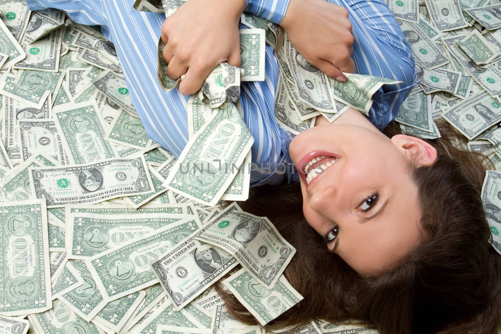 Beautiful woman laying in money