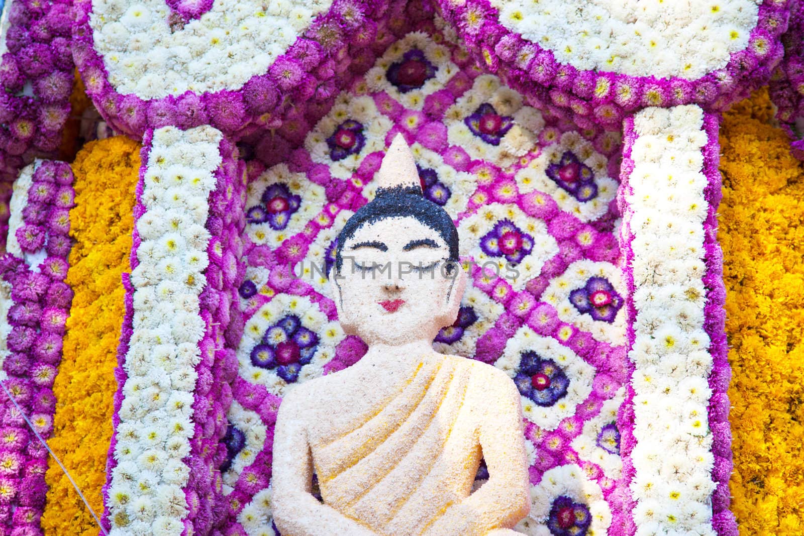 ornate Buddha from a temple flowers
