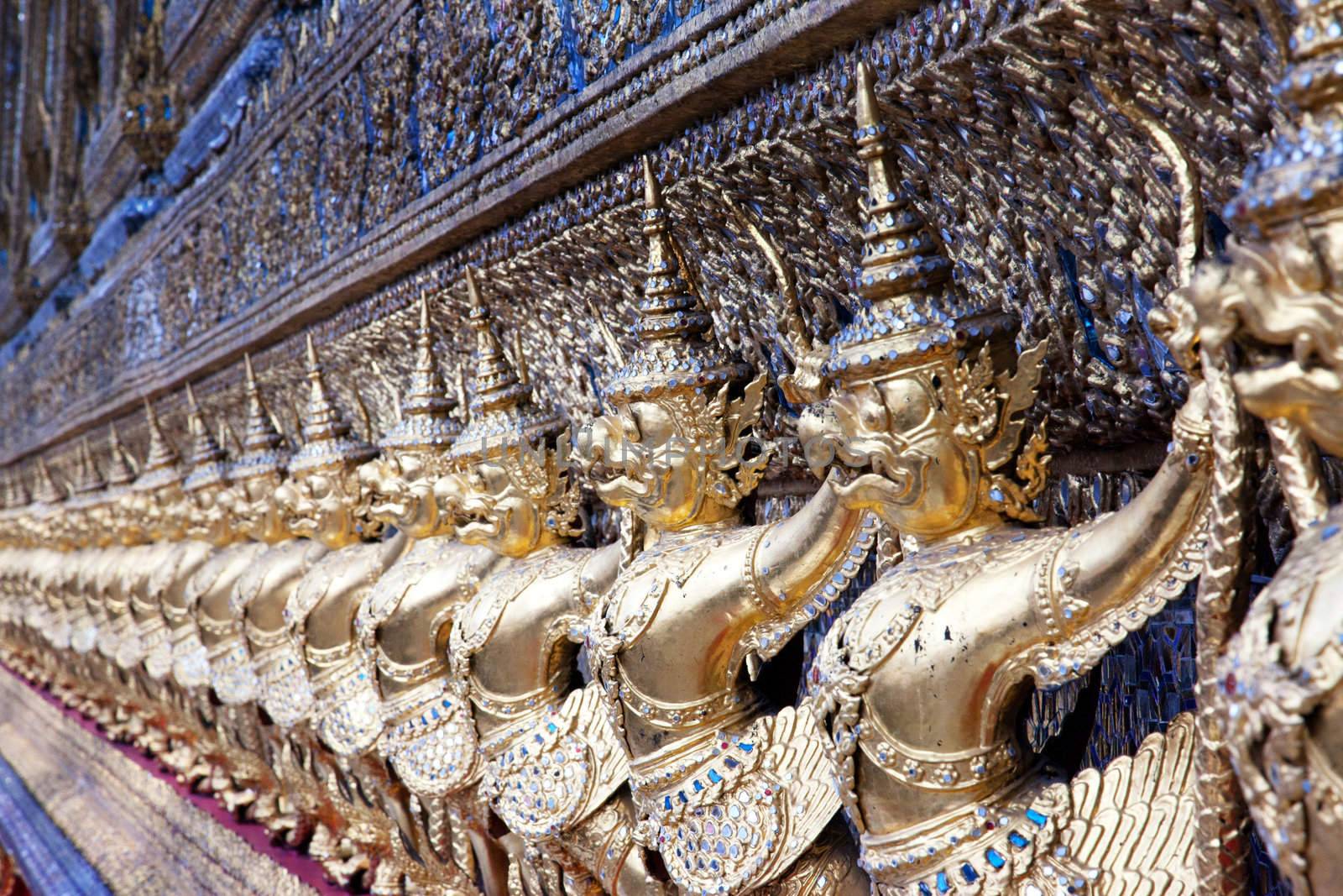 Relief gods of gold - many gods in a row - close-up
