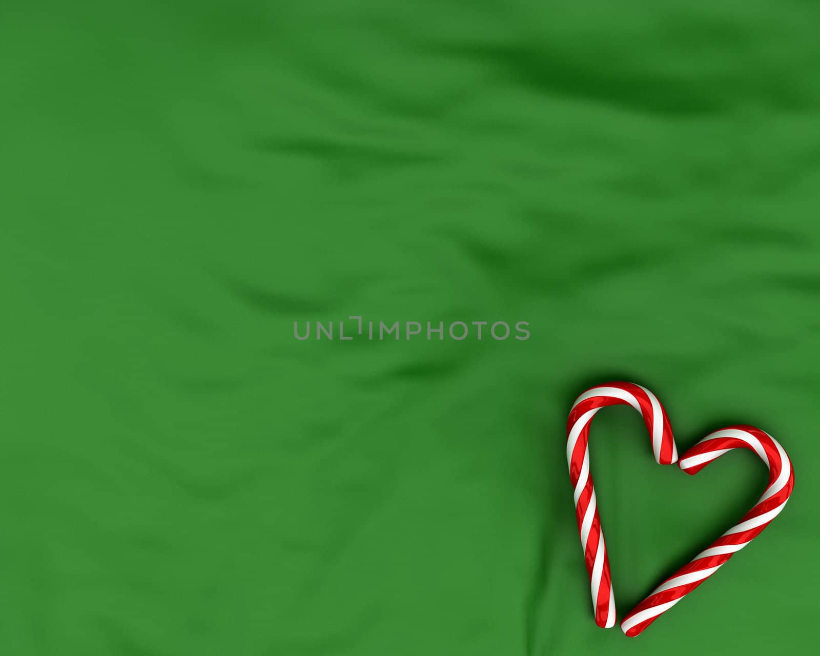 Heart made from christmas candies on green fabric background