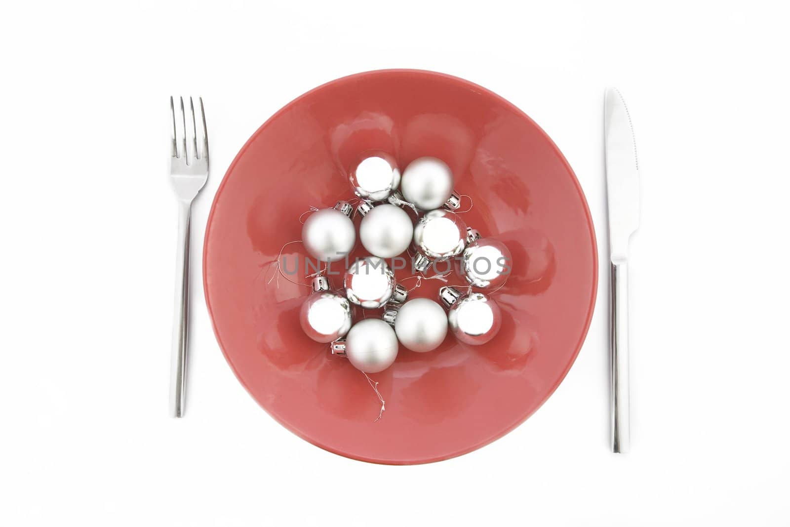 red plate with Christmas silver ball on white background