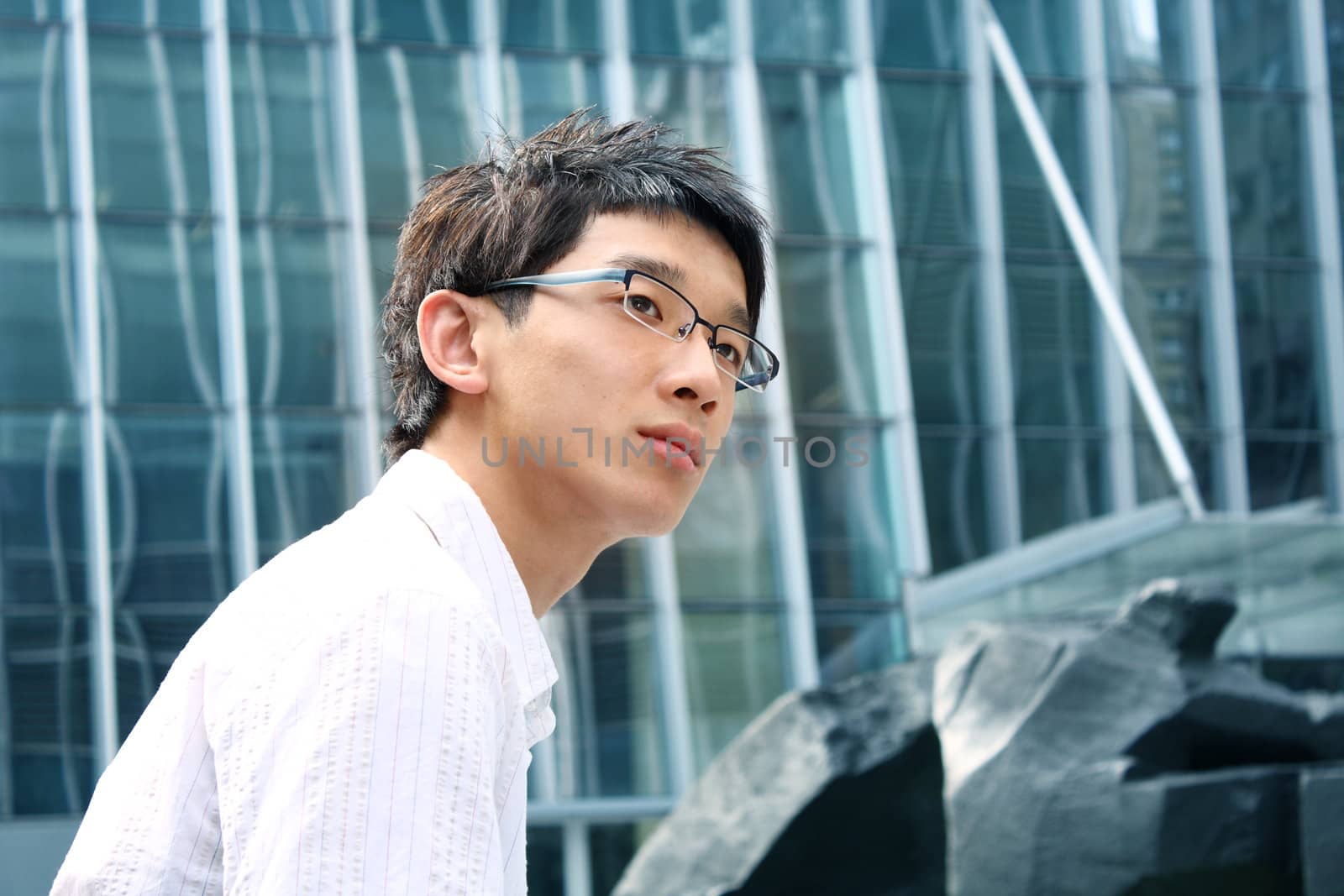 business man on modern glass building background at day