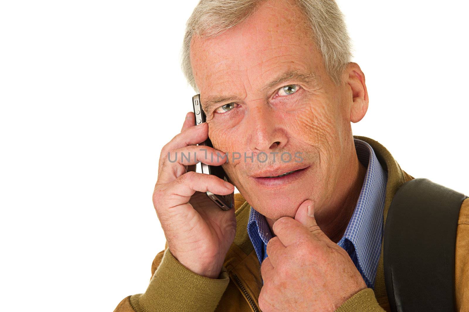Senior man taking on his smartphone. Smiling. Over a white background