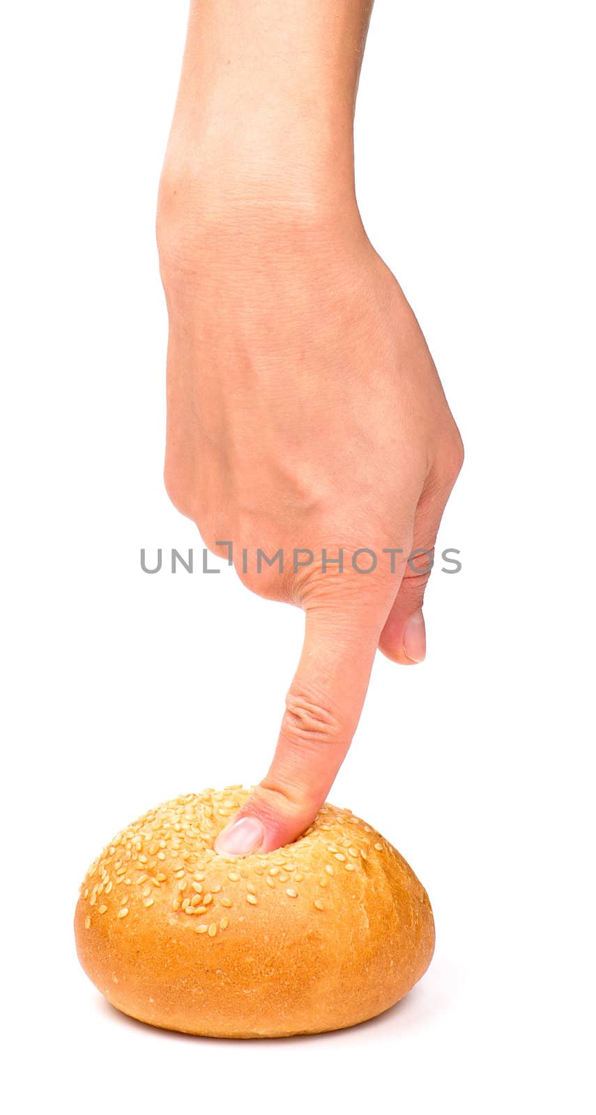 Finger pressing a fresh bun, isolated on the white background