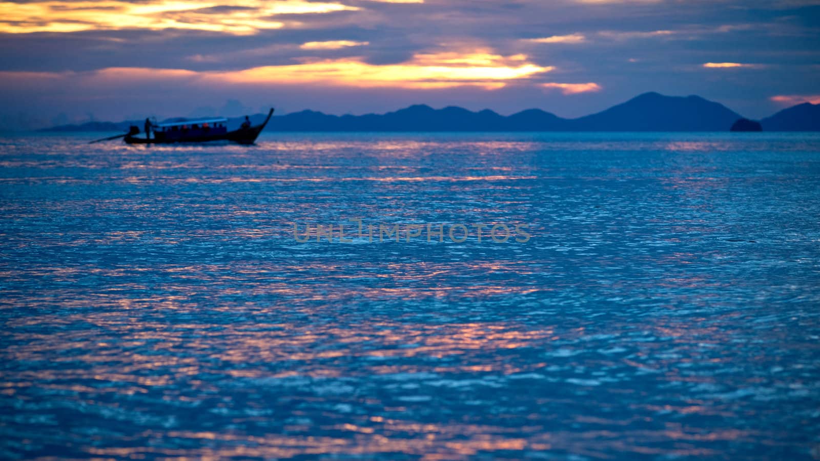 Silhouette of a boat in the sea at sunset