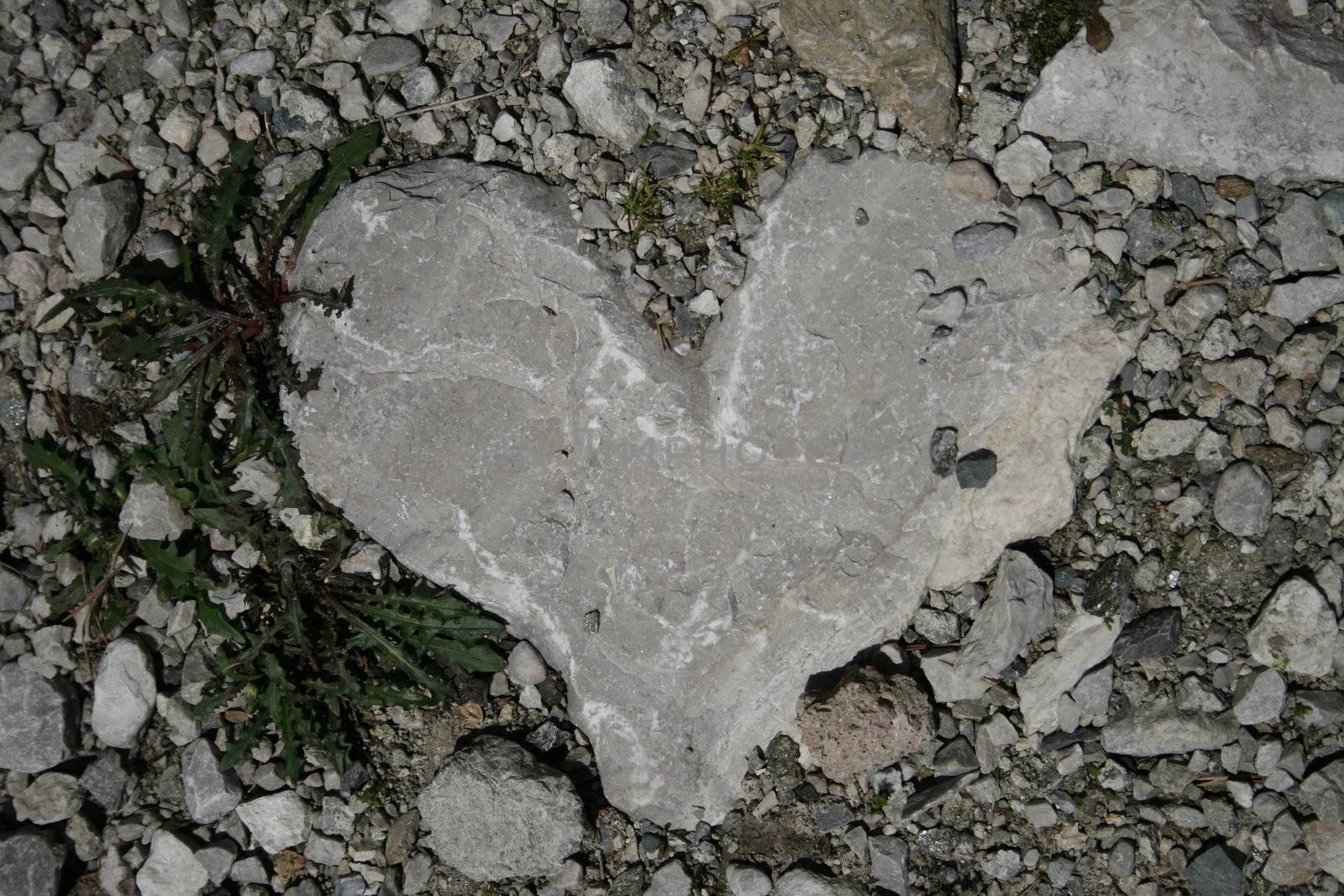 Stone heart in the middle on a walking way in the alps