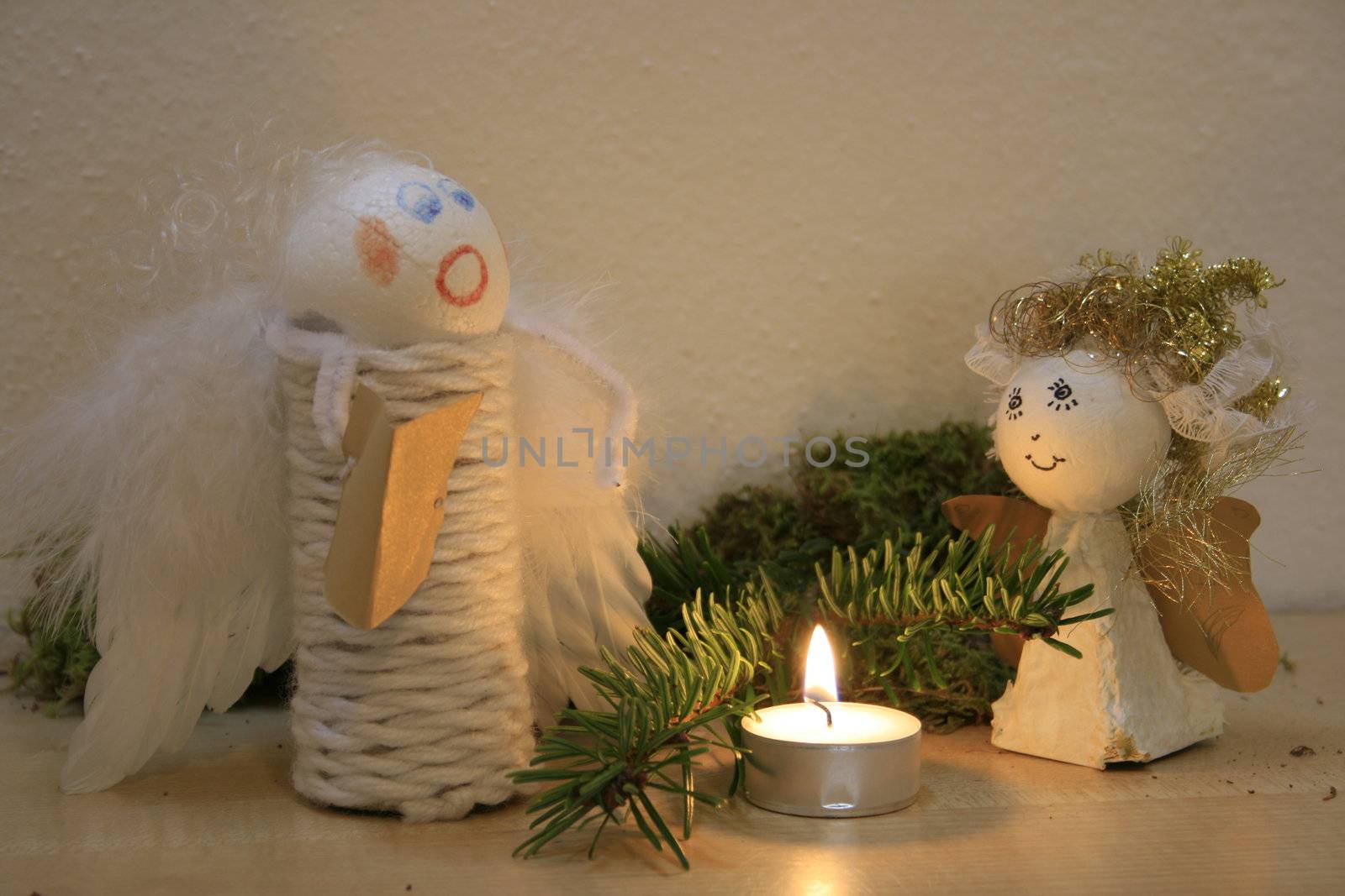 two christmas angles, candle, christmas ceiling, pine braches, moss