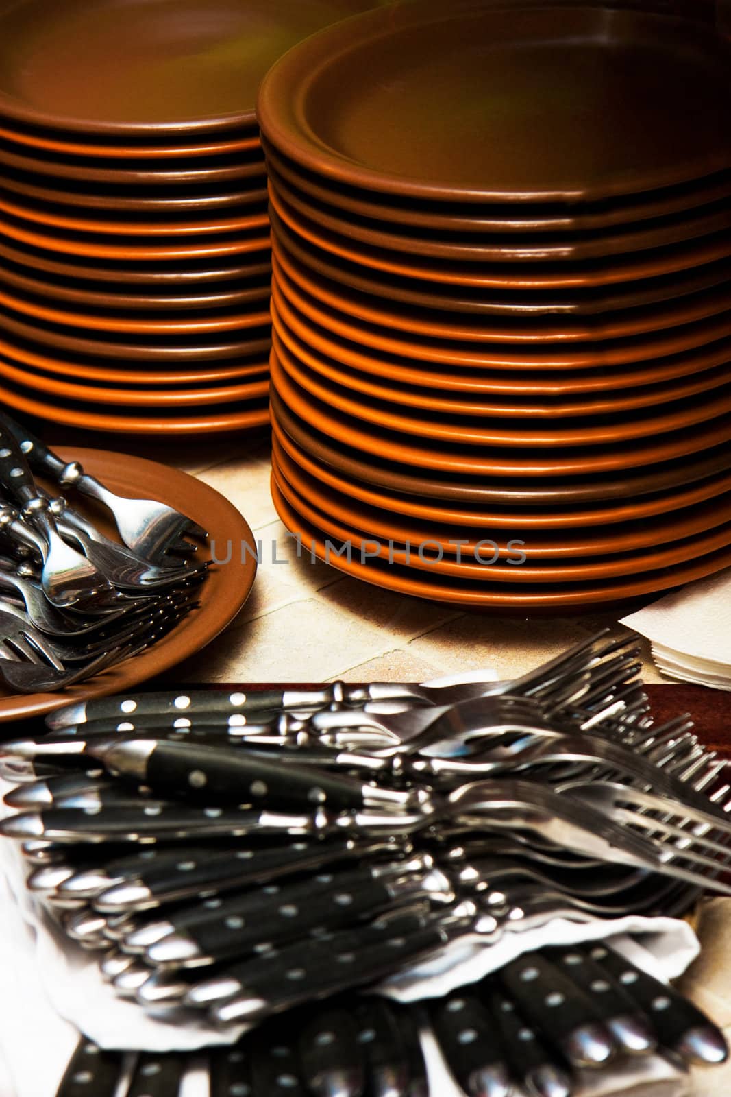 stack of plates and a lot of forks