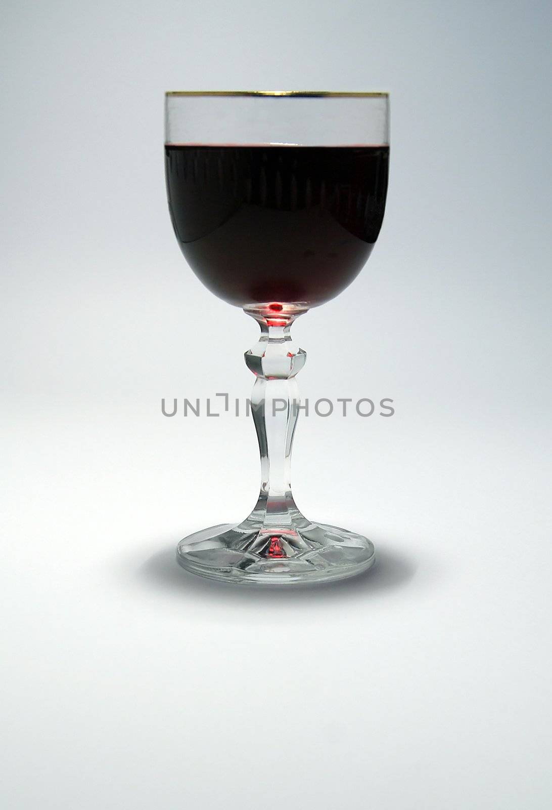 a glass of red wine on white simple background