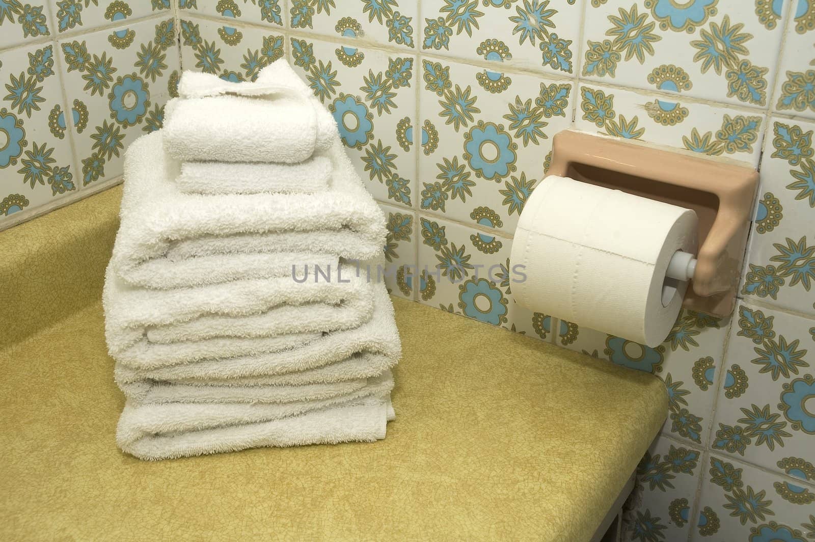 bathroom still-life, white towels and toilet paper,