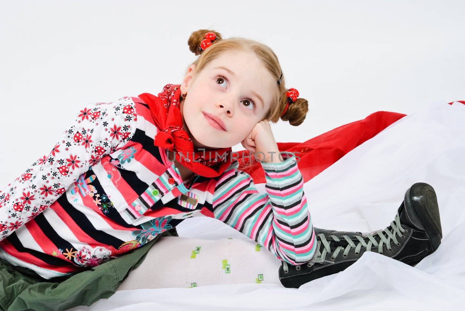 studio shot of pretty little girl with a red handkerchief around her neck