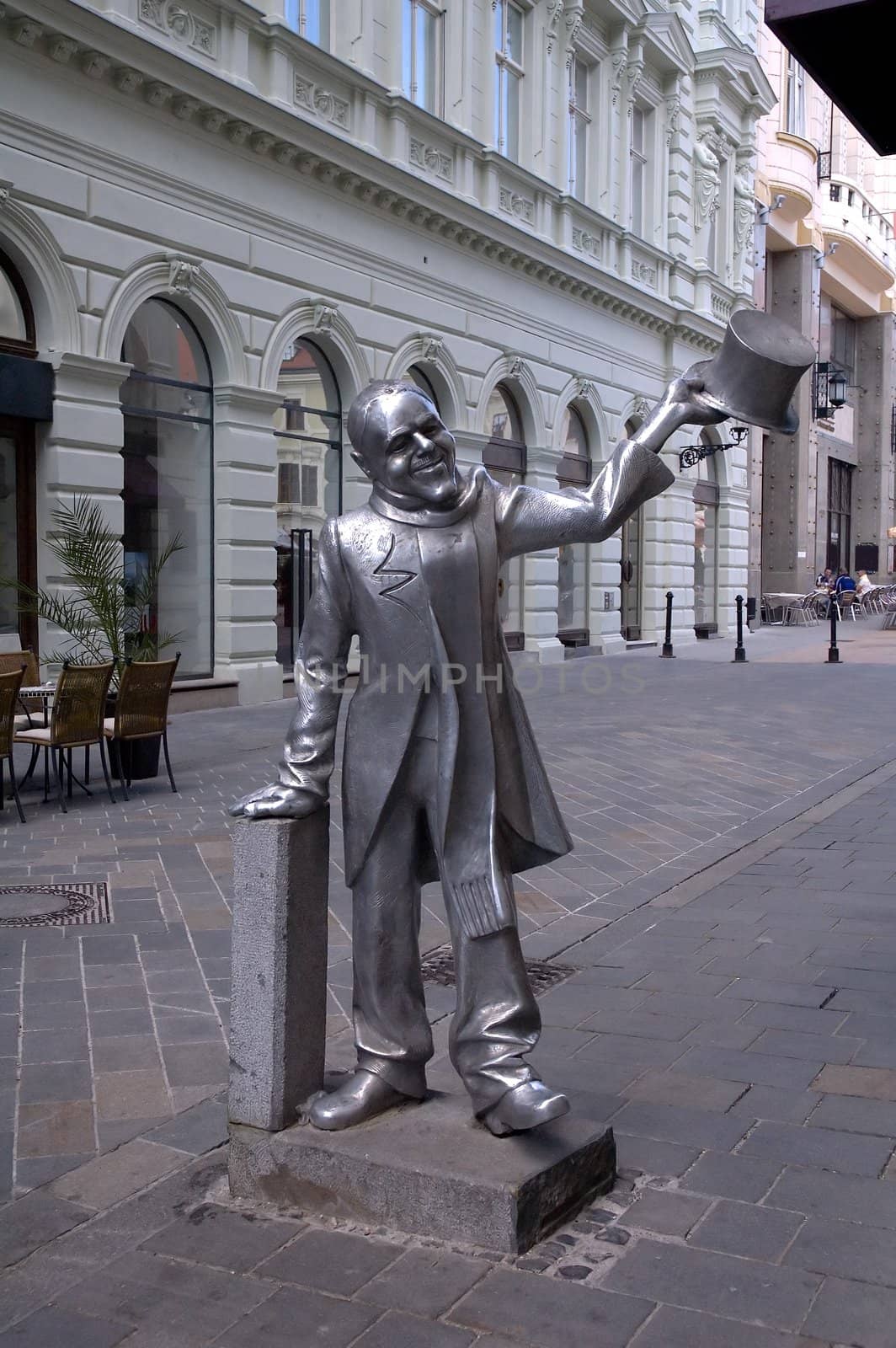 funny sculpture of an young man greeting with his cylinder, photo taken in bratislava