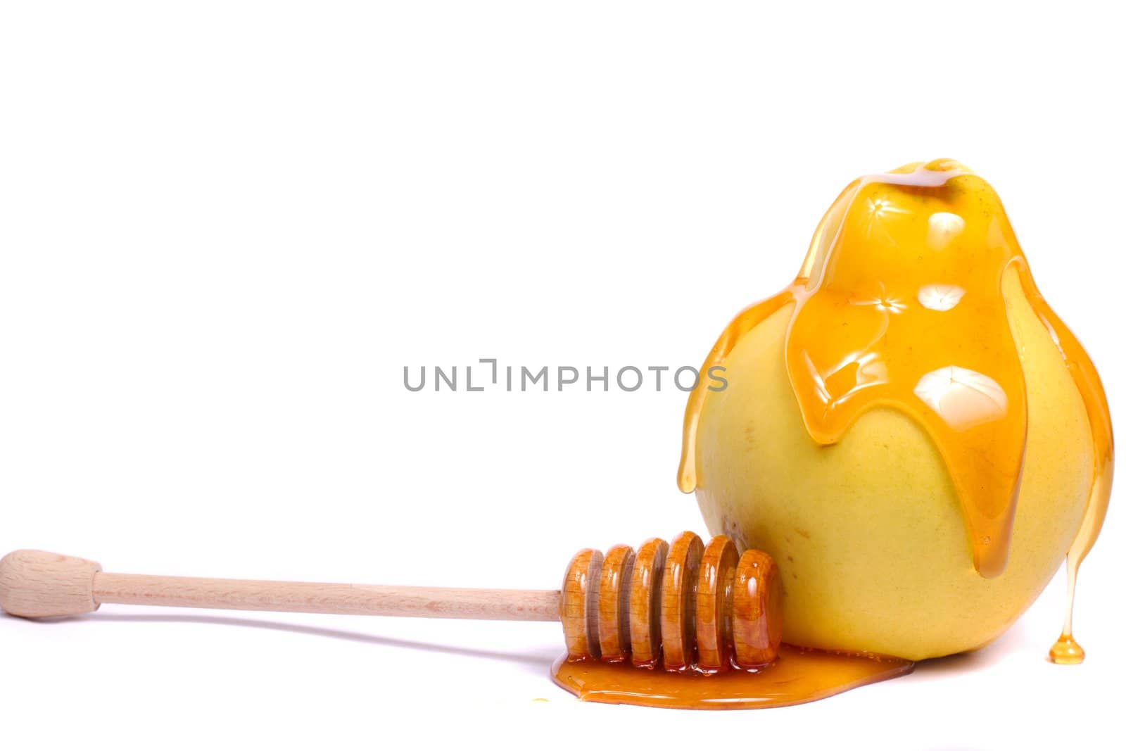 Close up view of a quince fruit with a honey dipper isolated on a white background.