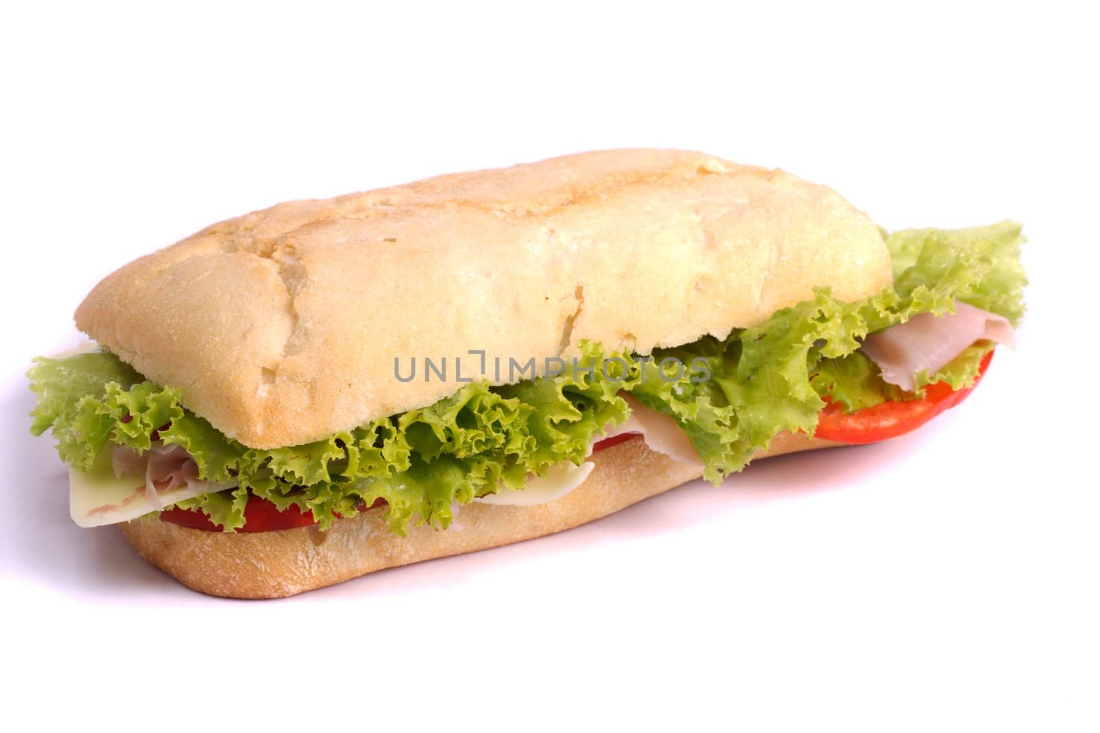 Close view of a fresh tasty ciabatta sandwich with tomato, lettuce, cheese and ham isolated on a white background.