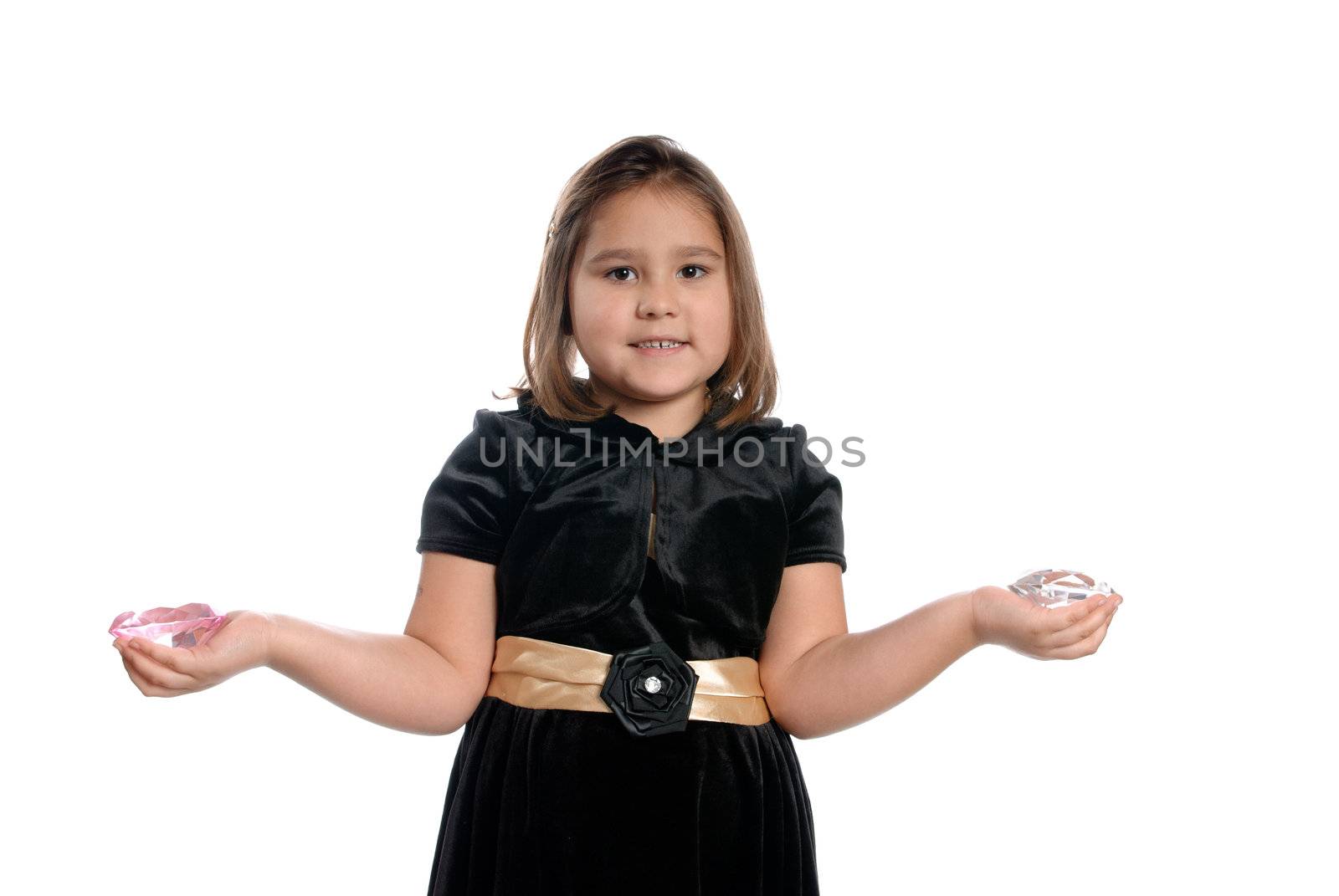 A 5 year old girl holding fake diamonds in her hands, isolated against a white background.