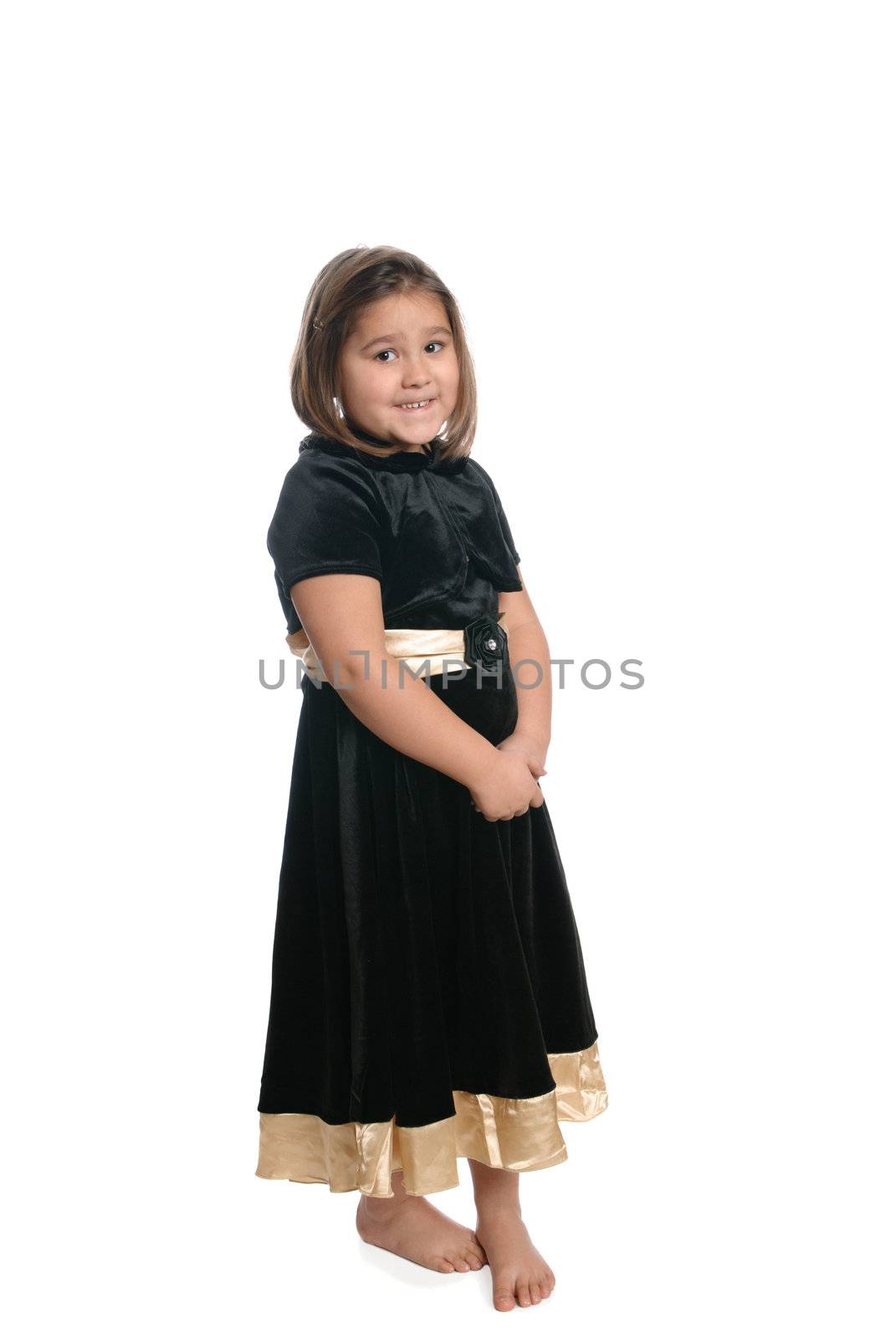 A young kindergarten student wearing a black dress is isolated on a white background.