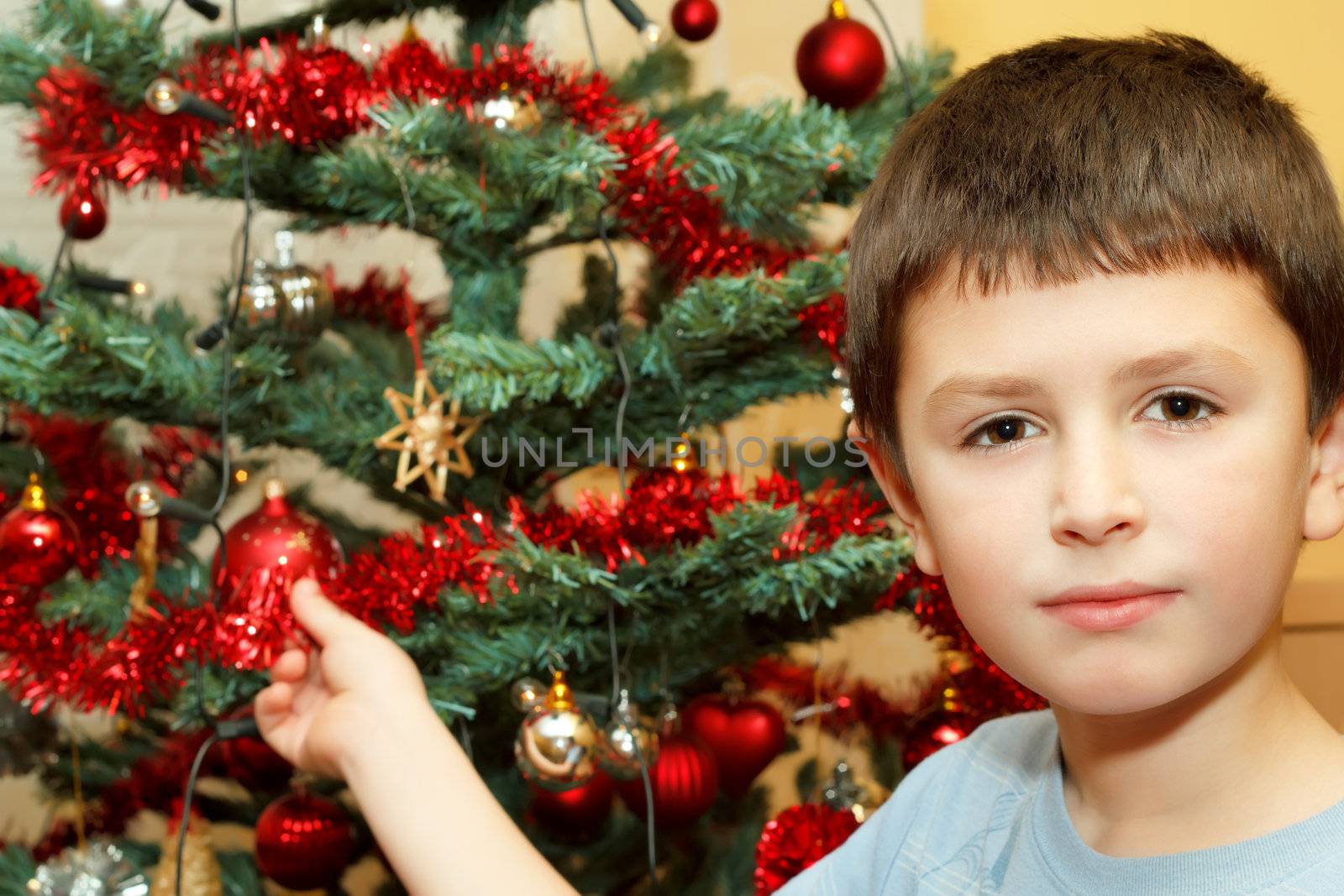 Young boy holding Christmas decorations by artush