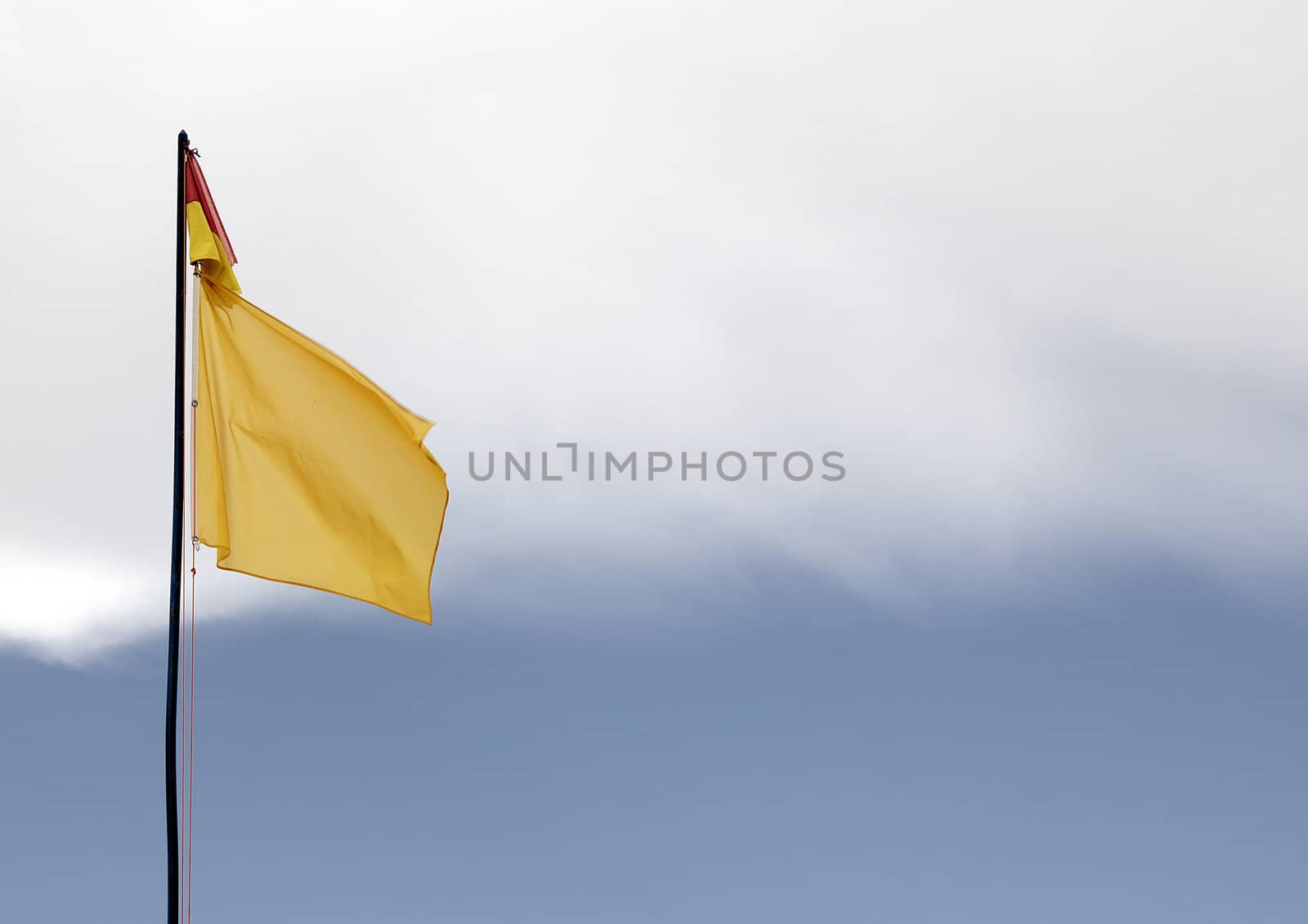 A red and yellow swimming safety flag on an Lithuanian beach