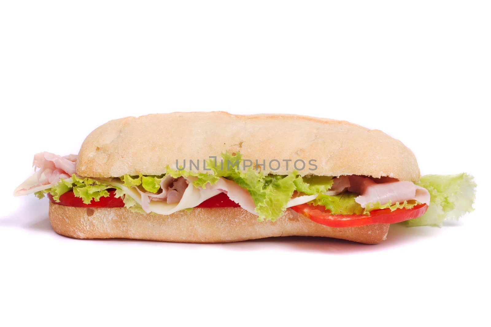 Close view of a fresh tasty ciabatta sandwich with tomato, lettuce, cheese and ham isolated on a white background.
