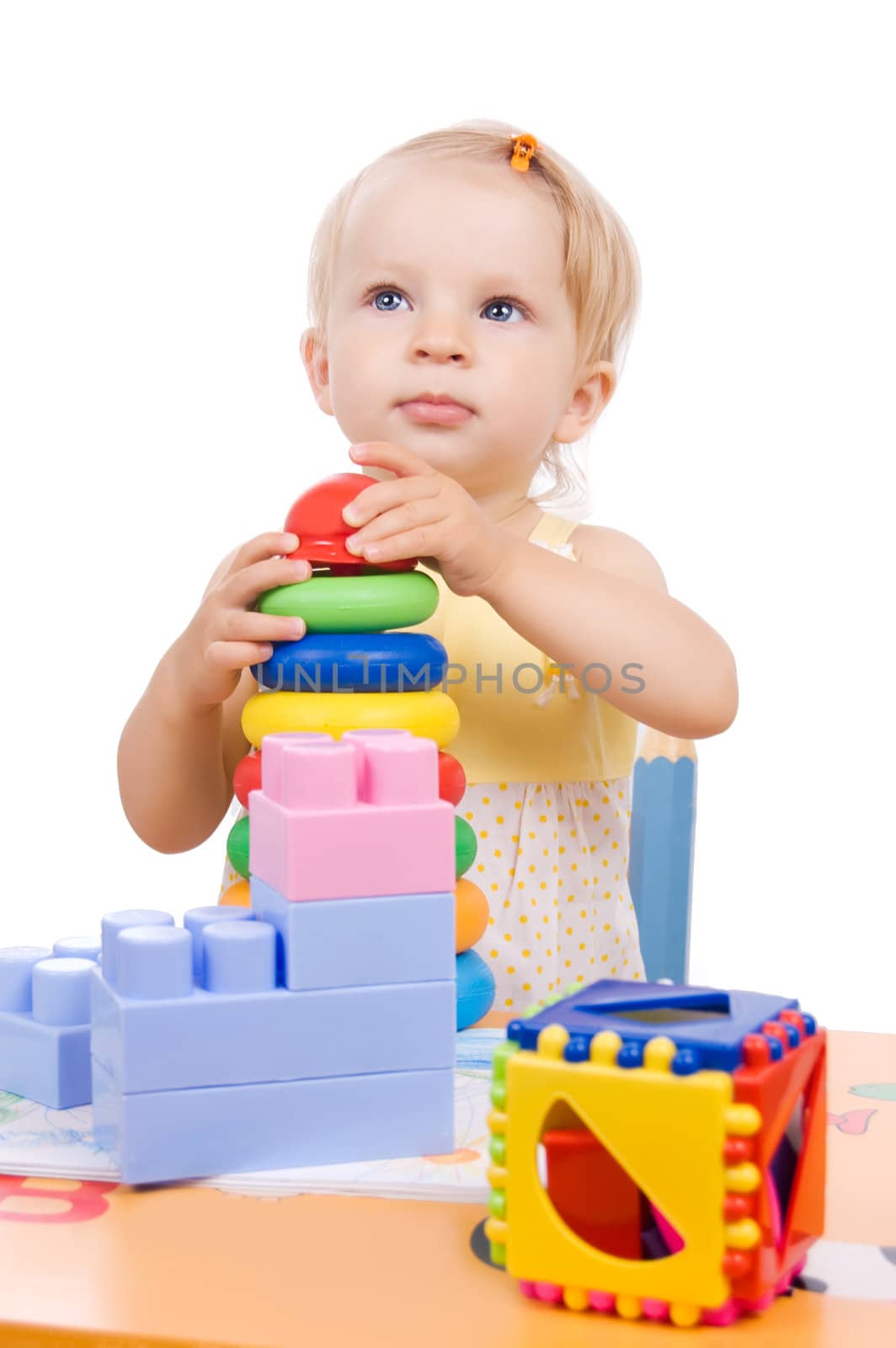 Baby girl playing pyramid over white