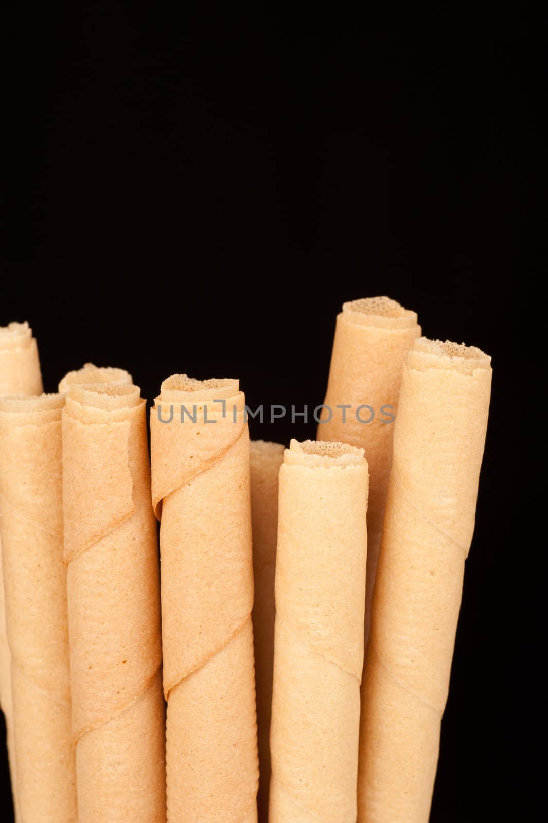 Detail take of rolled wafers isolated on black