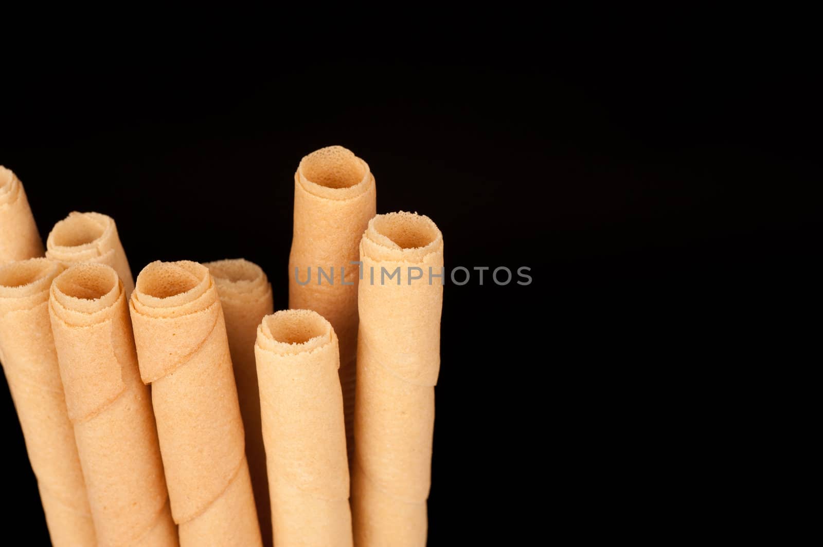 Detail take of rolled wafers isolated on black