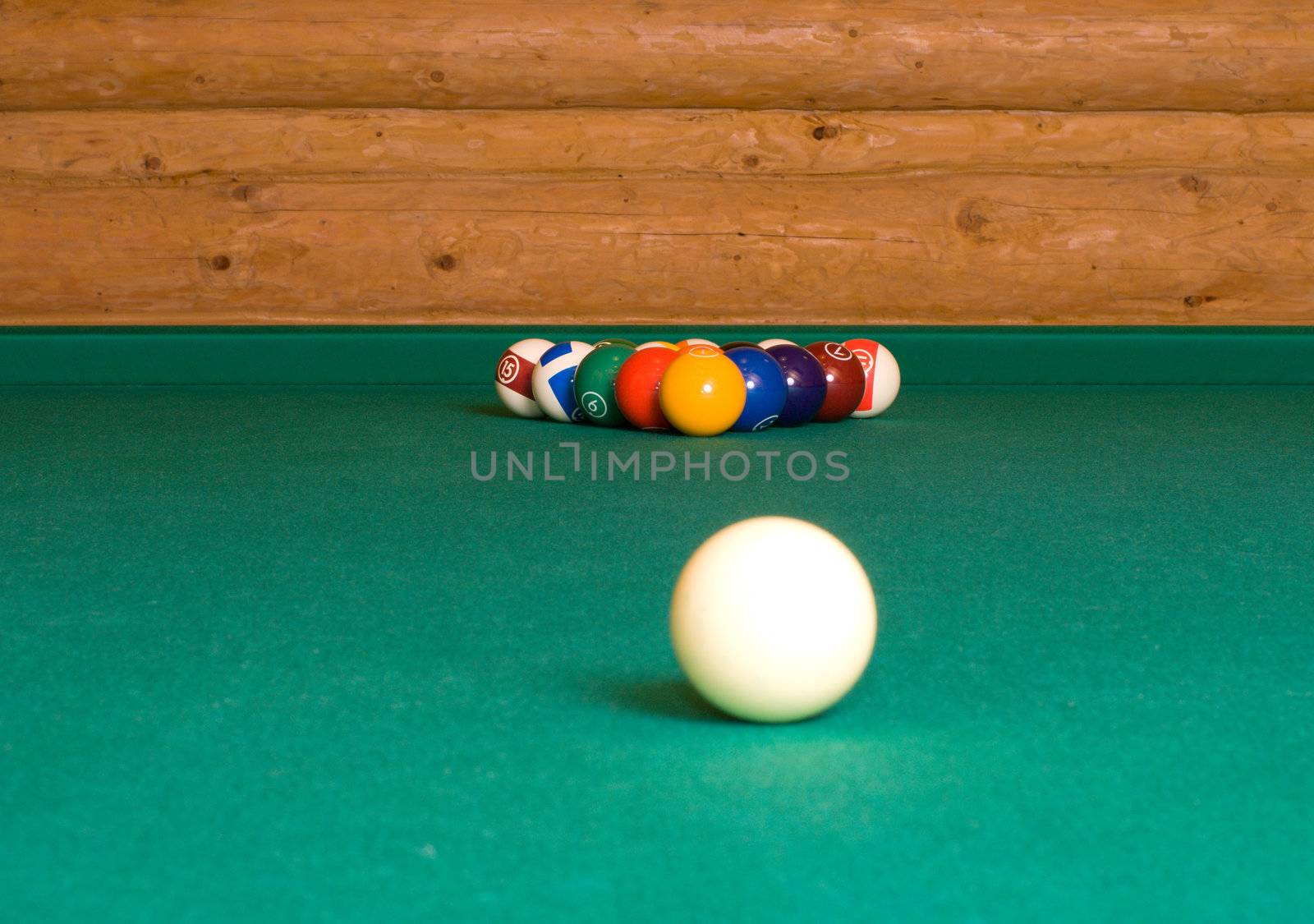 Pool balls on a billiard table before the starting hit.
