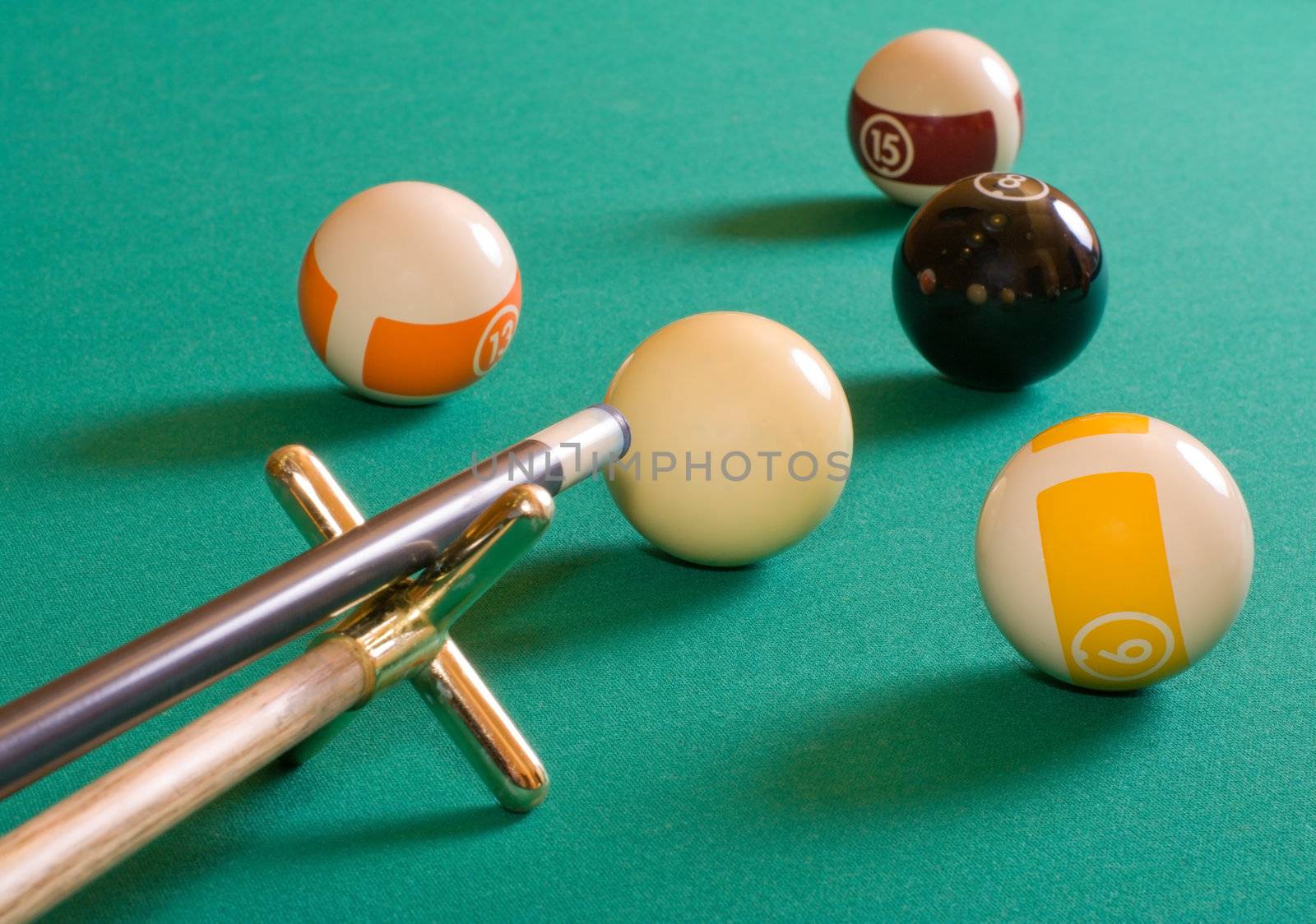 Cue and pool balls on a billiard table.