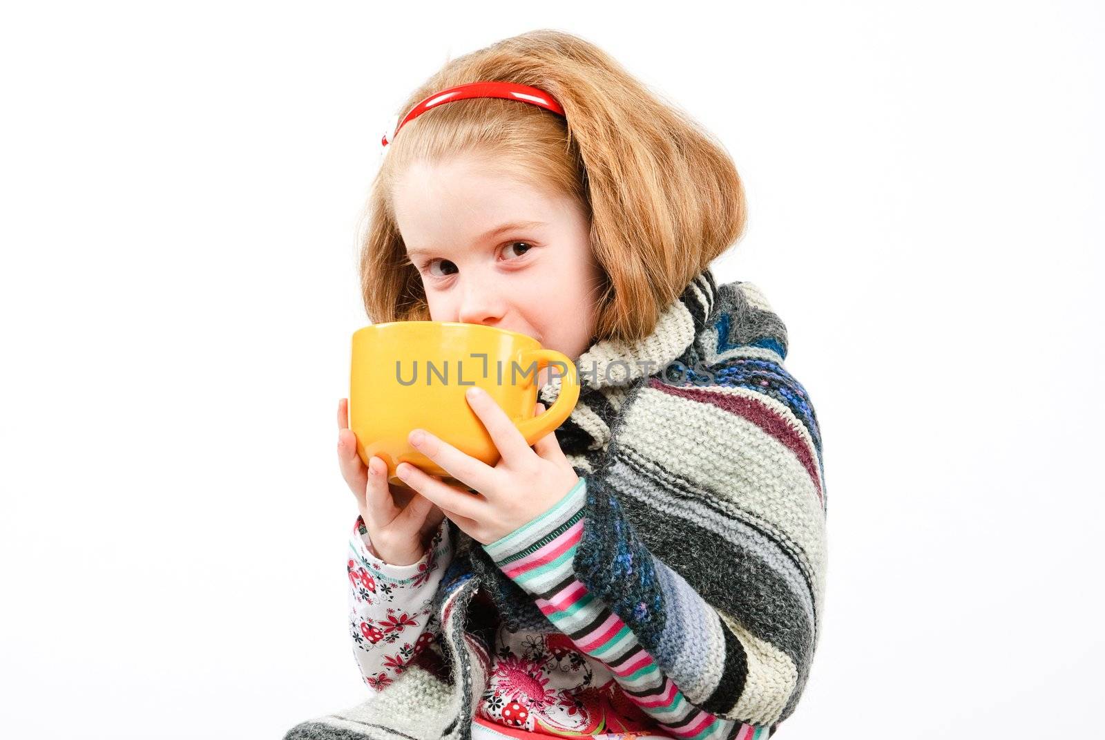 studio shot of pretty little girl with a cold holding a cup