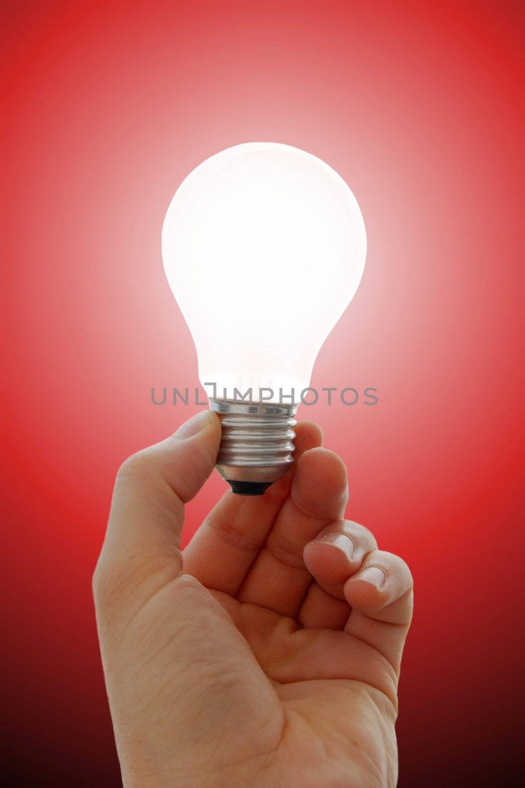 Glowing lightbulb in a hand