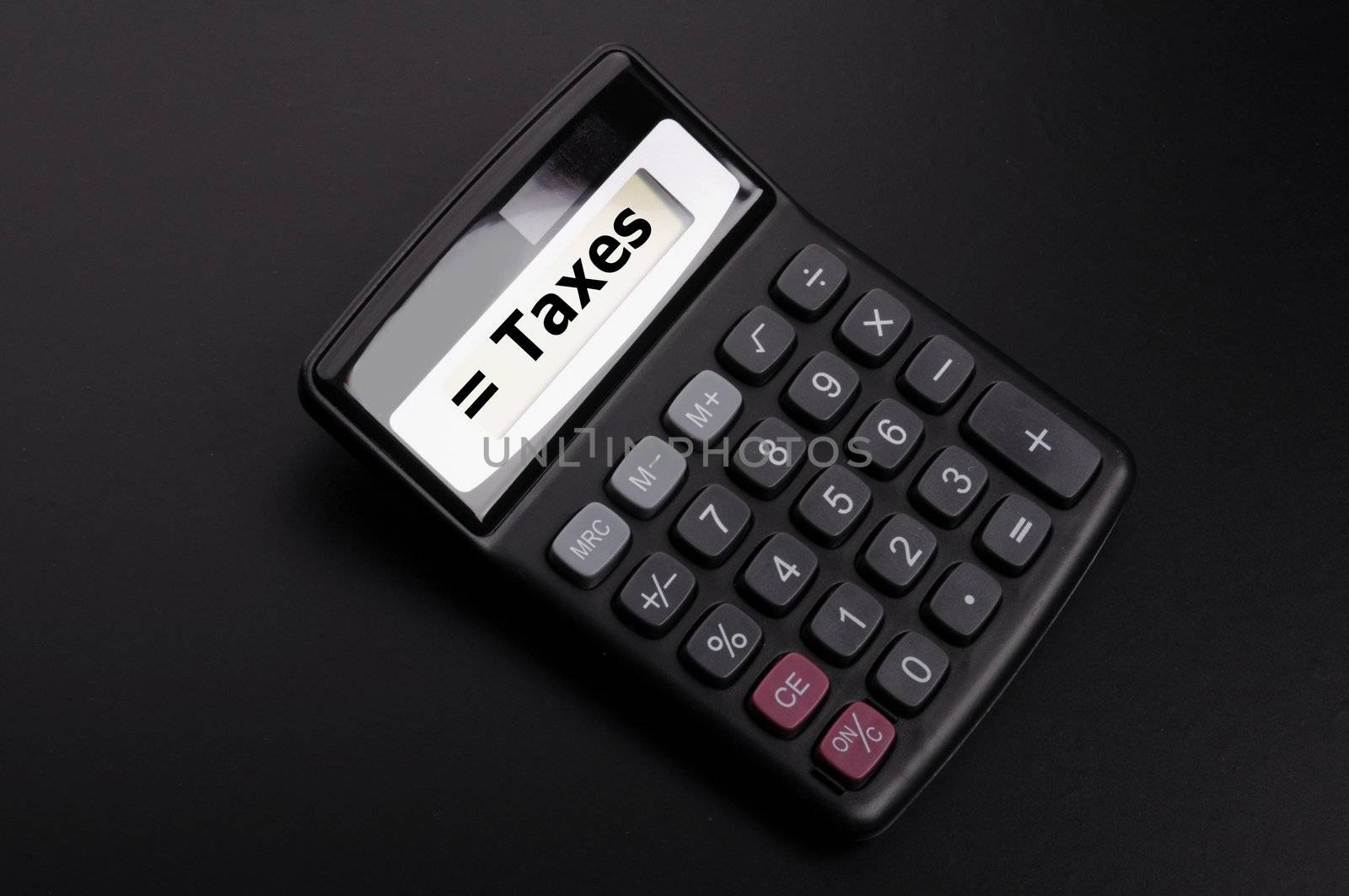 tax or taxes concept with business calculator and word