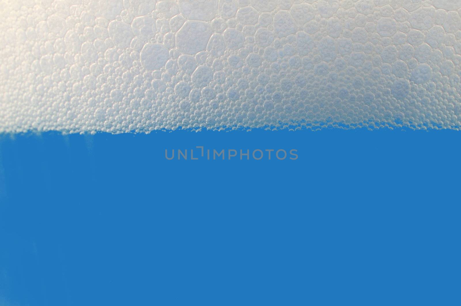 colored drink with foam isolated on white background