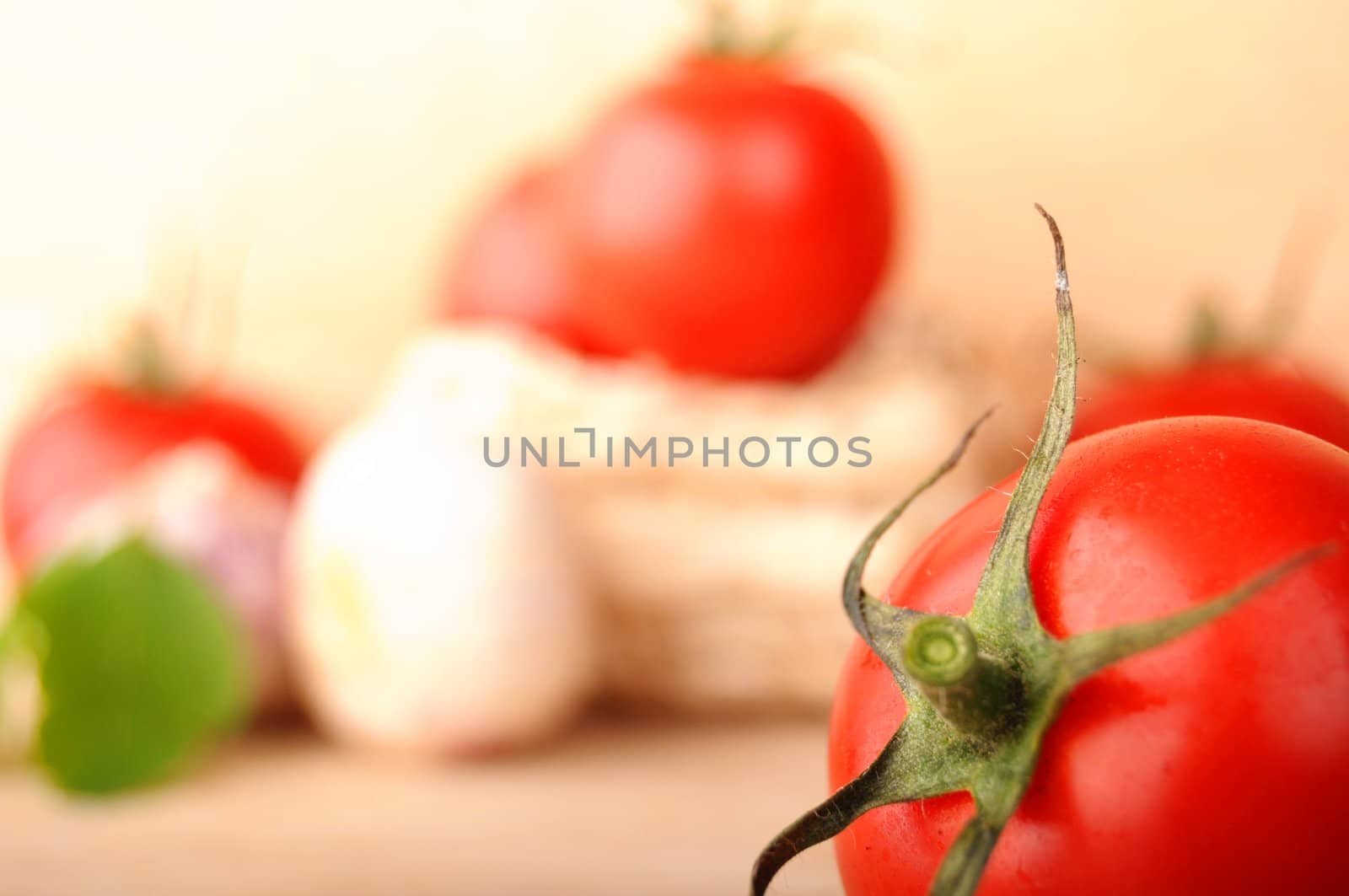 tomatoes garlic and other vegetables in kitchen showing healthy food concept