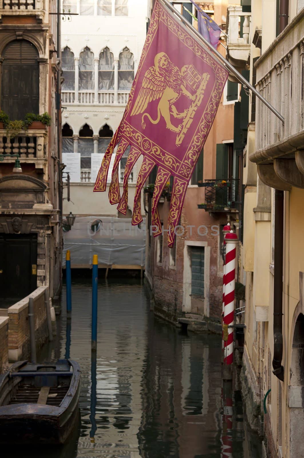 Venetian flag over canal in Venice, Italy