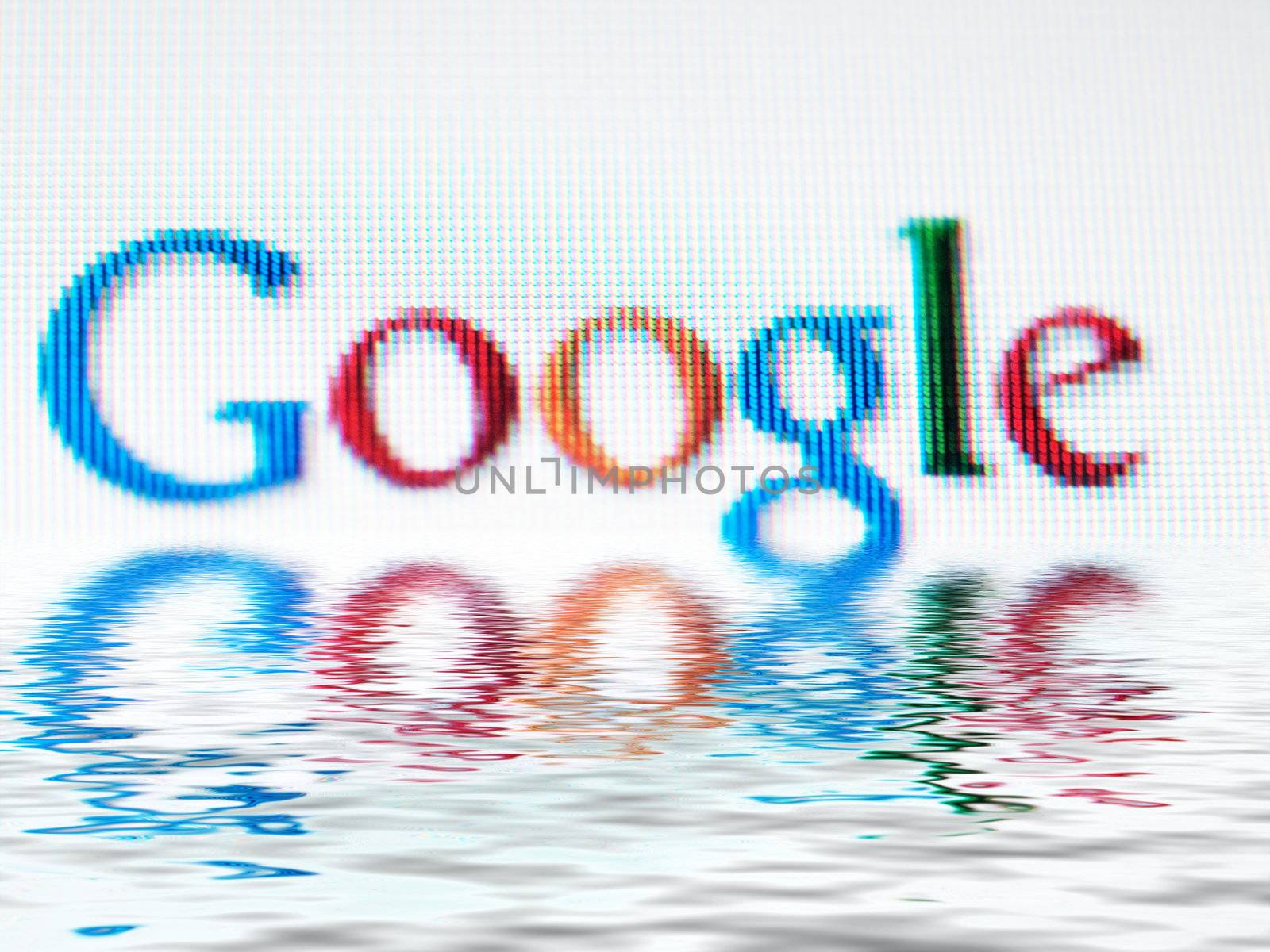 Macro of Google search engine company logo on a computer screen wth water effect
