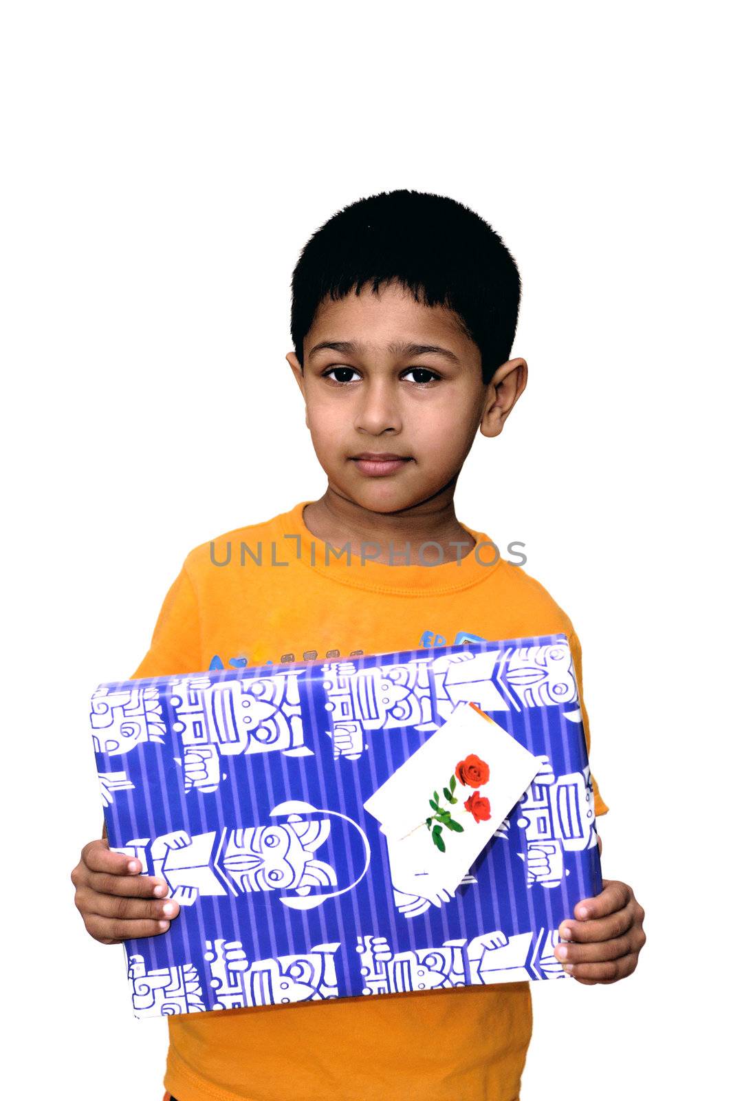 An handsome Indian kid holding a present for you