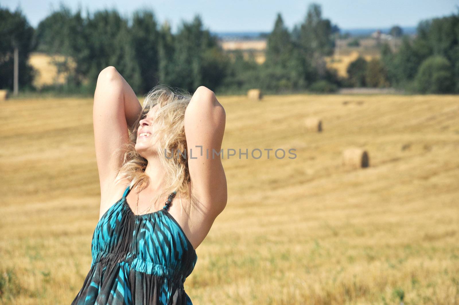 girl relaxing on a yellow wheat field under sun