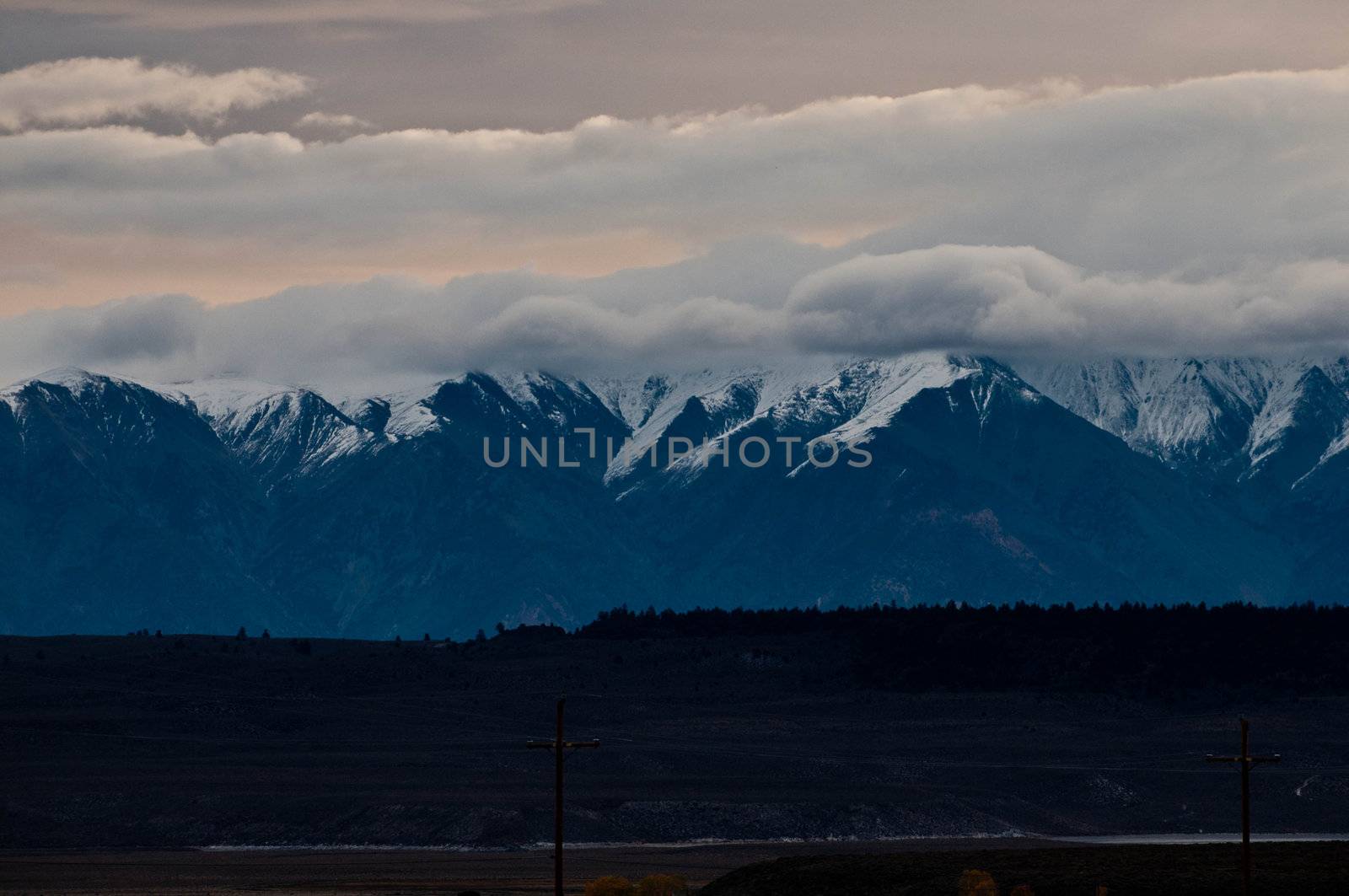 wild mountain landscape, snow-clad high peaks, snow and early morning