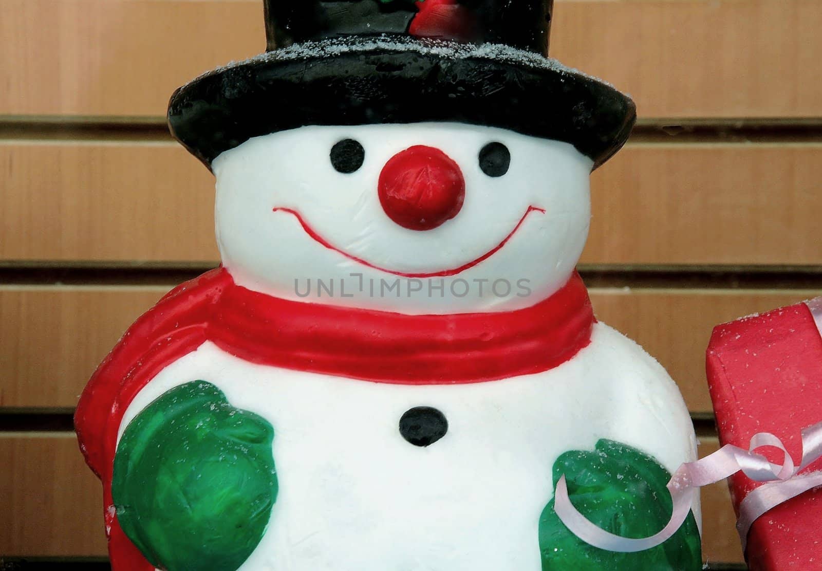 Snowman with his package present, waiting for christmas. Representation of the enjoyment and the happiness